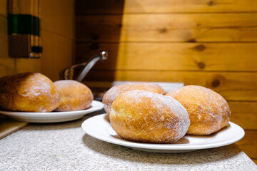 Traditional donuts or ponchik in the kitchen in wooden camping. Rest on lake Svityaz, Volyn region, Ukraine.