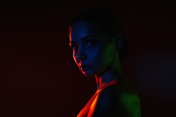 Female silhouette, beautiful woman in color lights