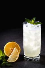 reshly squeezed lemonade with mint in a tall glass with ice.