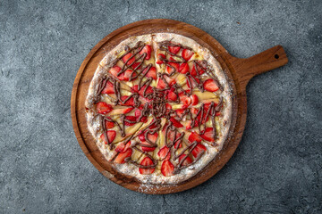 Tasty hot italian pizza for children with with strawberry, pear and chocolate. Pizzeria menu. Concept poster for Restaurants or pizzerias. Top view