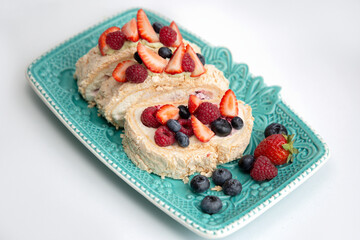 Delicious confectionery with berries on a blue beautiful plate