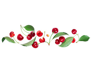 Ripe cherries with green leaves in the air on a white background