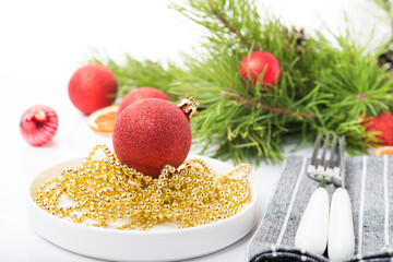 Christmas tree toys on a Christmas tree branch isolated on a white background, selective focus