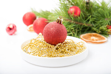Christmas tree toys on a Christmas tree branch isolated on a white background, selective focus