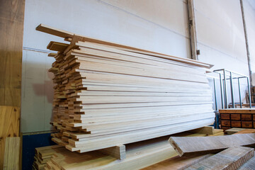 A pile of wooden boards on top of each other in a carpentry workshop