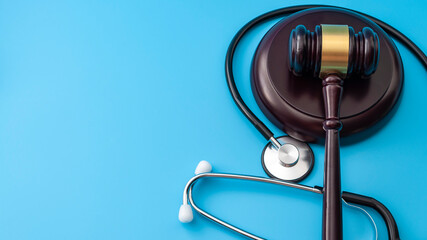 Healthcare legislation and regulation, medical malpractice decision and health care injury personal attorney concept with gavel and stethoscope isolated on blue background with copy space - 454190209