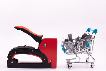 staples for a construction stapler in a shopping basket and a mechanical furniture stapler for...