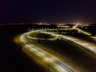 Highway road junction at night, aerial view