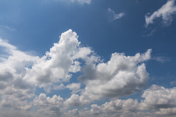 White porous clouds against a blue sky. The concept of lightness and serenity.