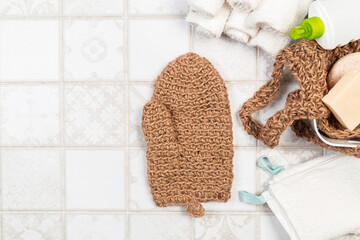 natural bathroom accessories, bath sponges for the body, soap and towels on a light background. environmentally friendly house