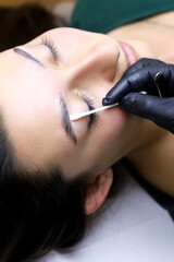 alignment of the line after the procedure lamination of the eyebrows with a special stick on which...