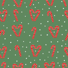 Seamless Christmas pattern . cute caramel canes and snow on a green background. vector texture. trend print for textiles, packaging and wallpaper.