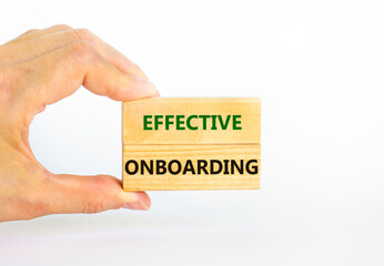 Effective onboarding symbol. Wooden blocks with words Effective onboarding on beautiful white background. Businessman hand. Business, HR and effective onboarding concept. Copy space.