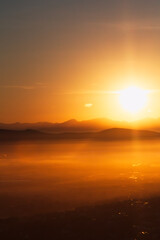 Sunover a misty valley