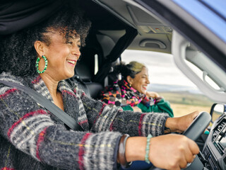 Smiling women traveling by car