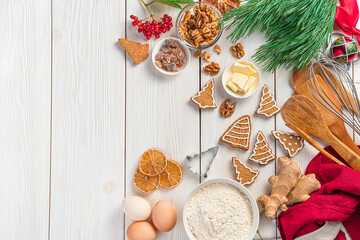Merry Christmas and Happy New Year. Festive culinary background with ginger cookies and ingredients on a white background. Top view, copy space.