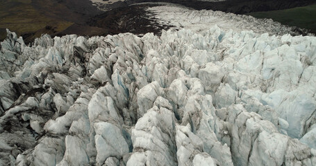 Aerial view over Glacier lagoon in Europe Fjallsárlón Iceland 
Ridges with black ash. Melting ice. Concept of global warming, February 2021
