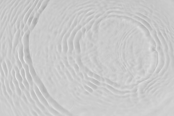 Fototapeta na wymiar Water tranquil ripple background. Water texture, circles and bubbles on a liquid white surface. Cosmetic products and flat design concept
