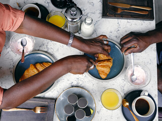 UK, Overhead view of couple having breakfastÊat hotel table - Powered by Adobe