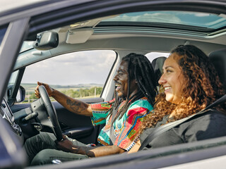 UK, Smiling man and woman in car