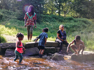 UK, Family playing in shallow creek