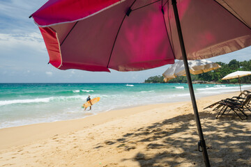 Umbrella and chairs colorful to sleep and relax on the beach.Surfboard on tropical beach in summer beach
