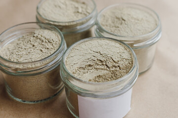 Ayurvedic cosmetic ubtan for face and hair care in glass jars. Vegetable ingredients ground into a powder
