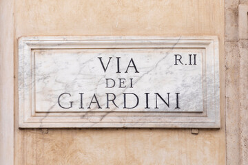 marble plate with Street name via del Giardini - engl: Giardini street - at the wall in Rome