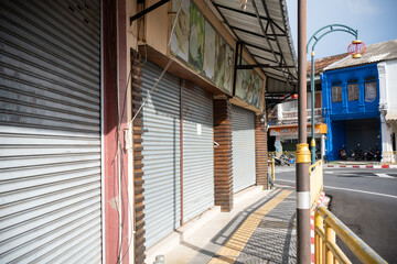 Corona-virus measures affect business  daily life.Shutters closed stores empty streets .Stay at home
