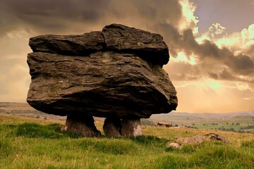 Dramatic cloudy sky frames a single perched erratic, part of the Norber erratics, near Settle in the Yorkshire Dales © Jenny