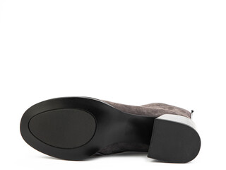 Women's autumn brown suede ankles with leather insert and medium heels isolated on white background.Shoe sole view. Fashion shoes. Photo shoot for shoe store concept.