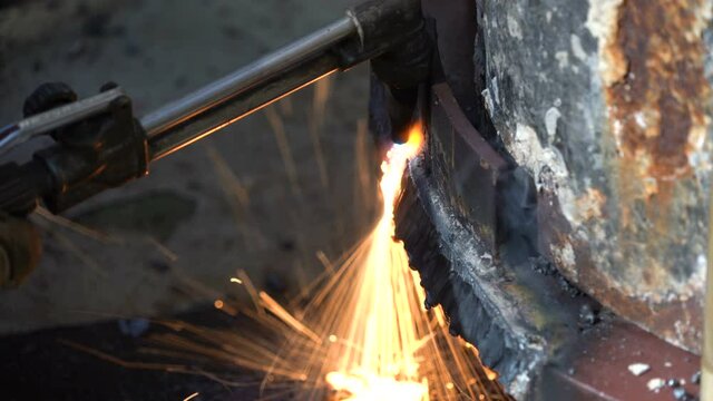 Blowtorch melts metal. lot of sparks around. Welding. Autogen. Cuts metal. Metal edge processing