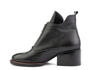 Women's autumn ankle black leather boots with black zip and average heels, isolated white background. Left side view. Fashion shoes. Photoshoot for shoe shop concept.