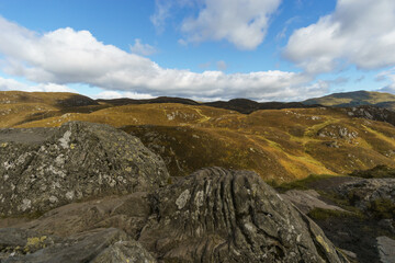 View over hills and rocks from Ben A'an in Loch Lomond and Trossachs National Park, Scotland,...