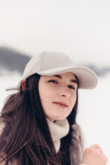 Stylish winter photo shoot of a beautiful woman in the middle of an icy lake in a small town.