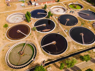 Round wastewater cleaning reservoirs at a sewage treatment facility. Grey water recycling, aerial view