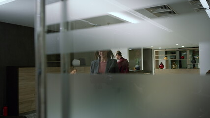 Businesswoman walking office with smartphone. Worker pressing lift button