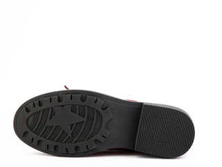 Women's autumn red leather jodhpur boots with black sole isolated on white background. Sole view. Fashion shoes. Photoshoot for shoe shop concept.