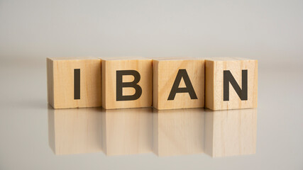 Four wooden cubes with letters IBAN. Business marketing concept
