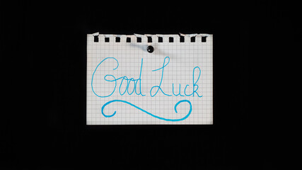 Hand written message on a ripped notebook sheet, 