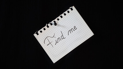 Hand written message on a ripped notebook sheet, 