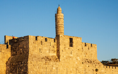 Naklejka premium Tower of David fortress at dusk with blue sky in the background in the old city of Jerusalem Israel September 2021