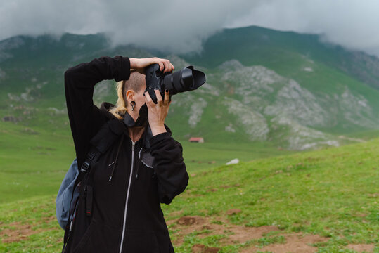 person taking landscape photography in the mountains on a stormy day.
