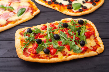 Assortment of Traditional italian pizza with vegetables olives tomatoes and ham