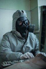 Scientist dosimetrist radiation supervisor in protective clothing and gas mask explores the danger...