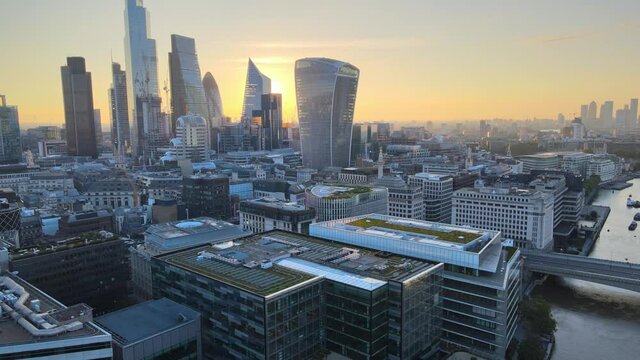Aerial morning view of urban neighbourhood. Shot of downtown skyscrapers against colourful sunrise