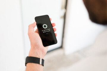 Person opening the ride sharing app on the phone