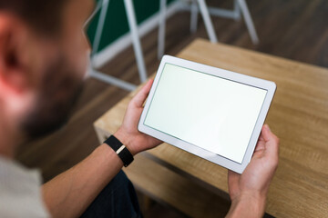 Young man looking at his tablet