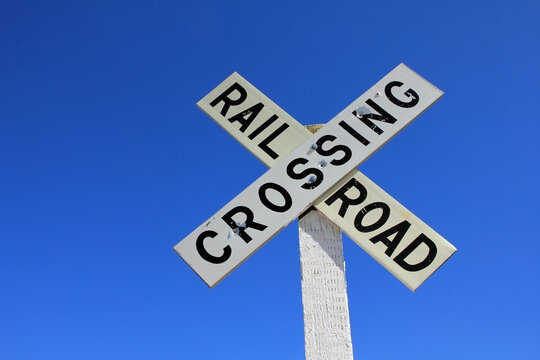 railroad crossing sign on blue sky