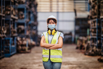 confident pose of the engineer  women wear  mask while standing with his arms crossed